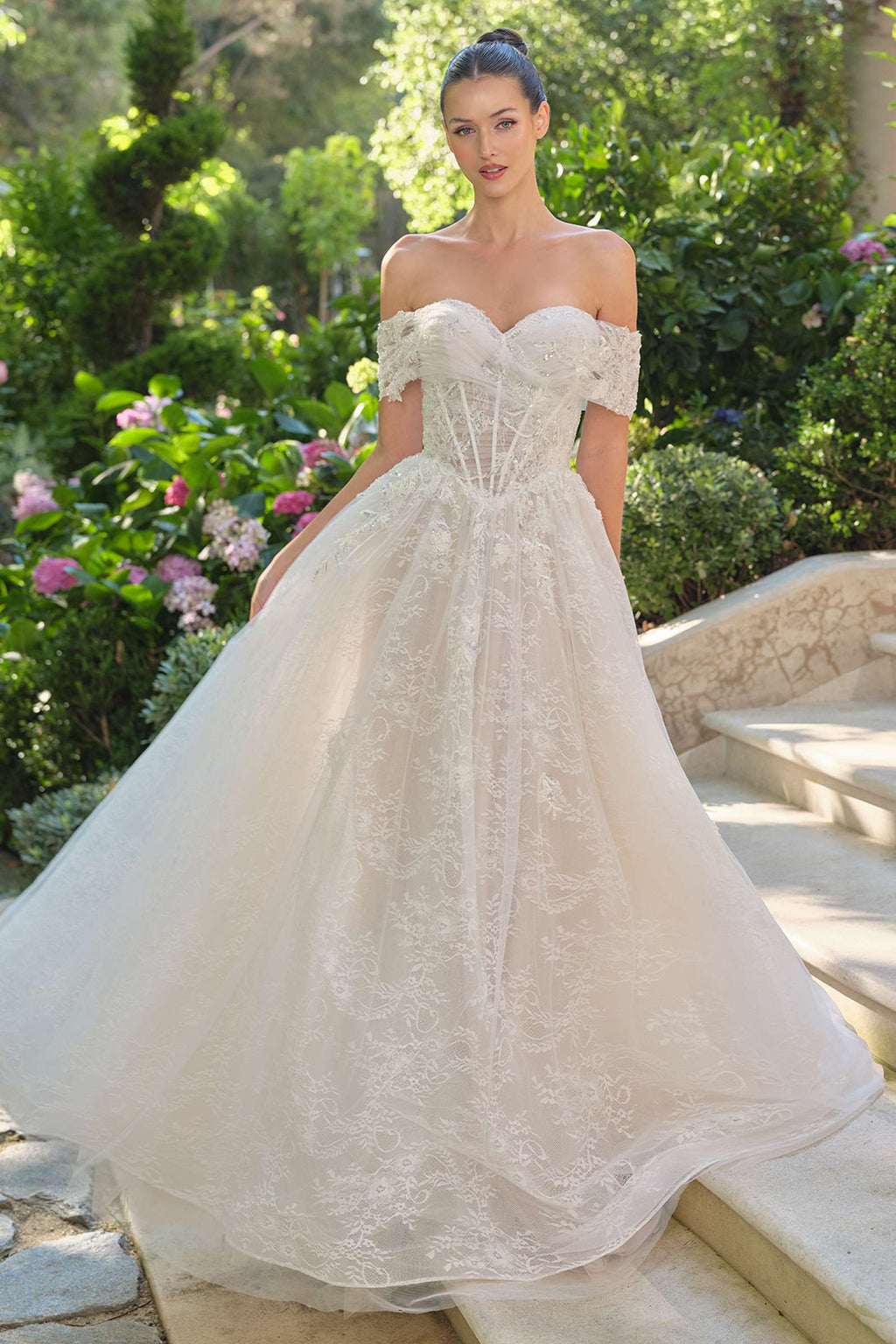 Andrea & Leo WL090 is a women’s wedding dress for wedding, formal events. Source details list a Ball gown silhouette. Design details include Off-the-shoulder ruched neckline, sheer corset bodice, and 3D floral appliqué. Fabric/material details: Embroidered lace tulle over layers of soft mesh. Fit detail: Exposed boning corset for support and shape; full gathered skirt for volume. Colors listed: off white/nude. Use the product options for exact color and size selection.