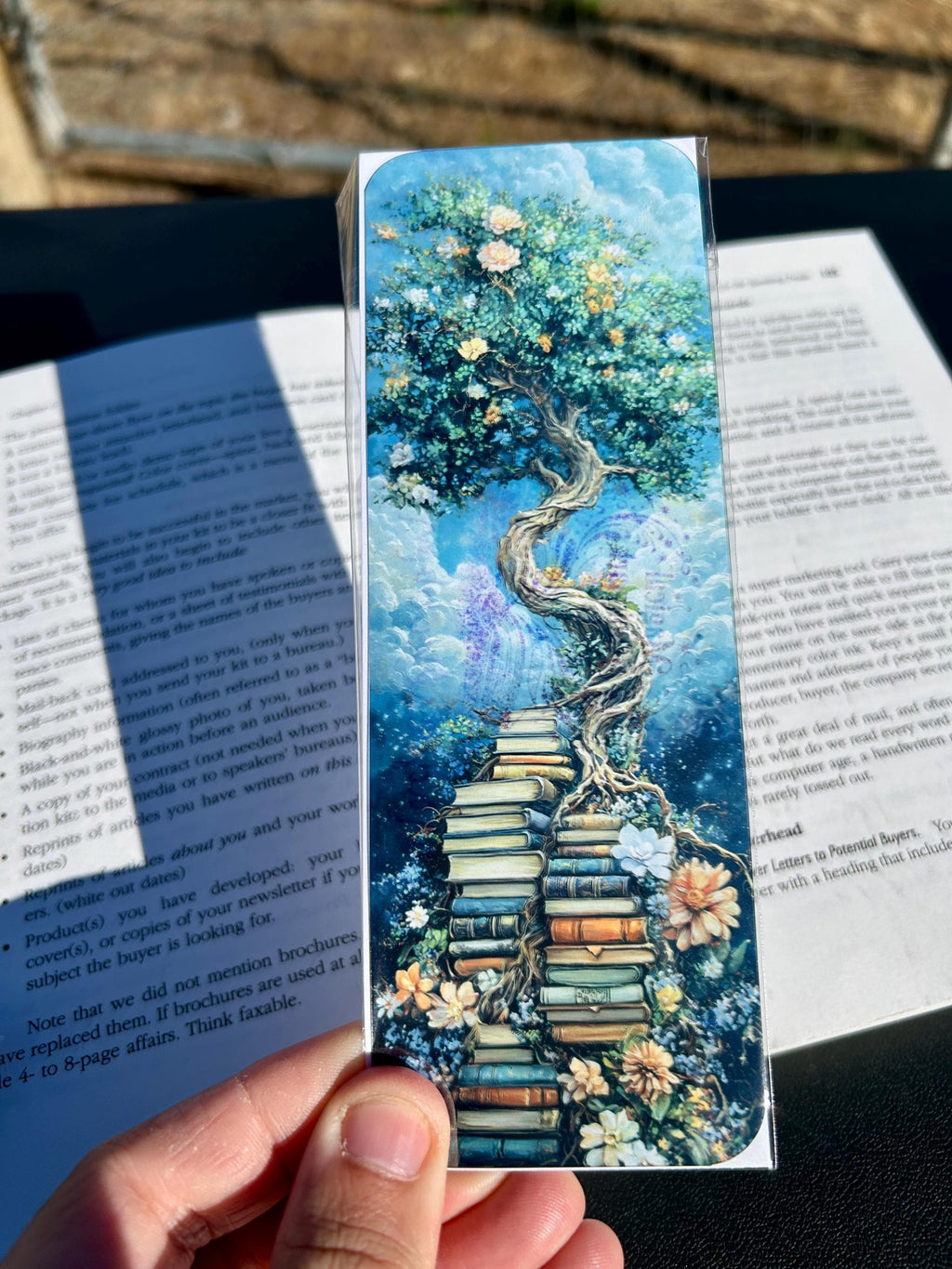 Enchanted Tree of Knowledge Bookmark – Whimsical Fantasy Tree Growing from Books with Flowers and Clouds, Book Lover’s Bookmark is a decorative bookmark made for readers, book lovers, collectors, book clubs, and giftable literary moments. It is designed as a reading accessory for books, journals, planners, and cozy reader gifts.
