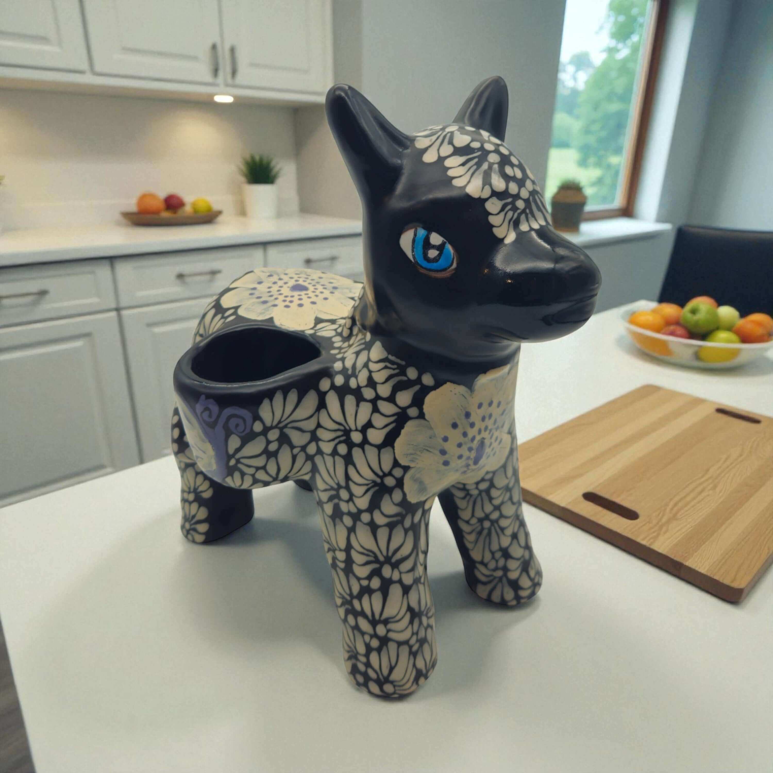 Floral Black & White Talavera Donkey Planter | Mexican Pottery is a hand-painted ceramic planter made for plant displays, garden accents, windowsills, patio styling, and colorful home decor. It is a home and garden product made for decorative plant displays and giftable home styling.