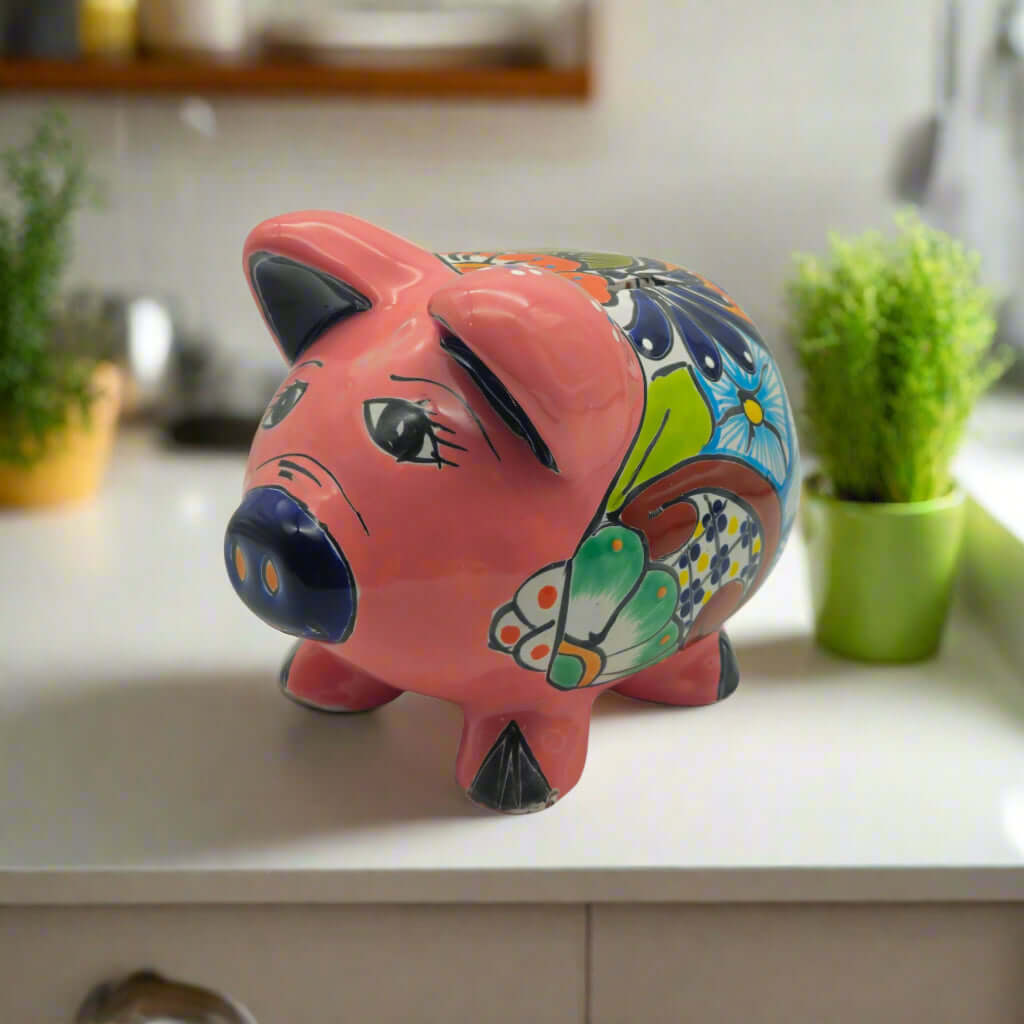 Hand-Painted Talavera Piggy Bank | Mexican Folk Art Design is a hand-painted ceramic piggy bank selected for decorative saving, shelf styling, collector displays, and cheerful gift giving. It is a home decor item for shelves, gifting, and collector displays.