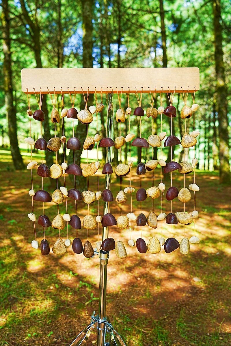 Handmade Rainforest Wind Instrument | Juju, Chacha & Panji Mixed Seed Bar Chime is a handmade wind chime selected for home decor, patio accents, porch styling, and giftable nature-inspired displays. Material details include Made only from naturally fallen seed shells and sustainable wood. Available style options help shoppers choose the right version from the listing variants.